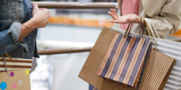 women discussing purchases in shopping mall TG2KVQJ